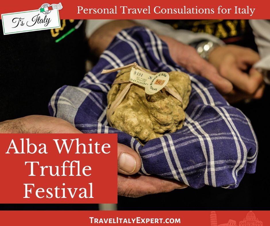 Man holding white truffle in blue checked cloth.