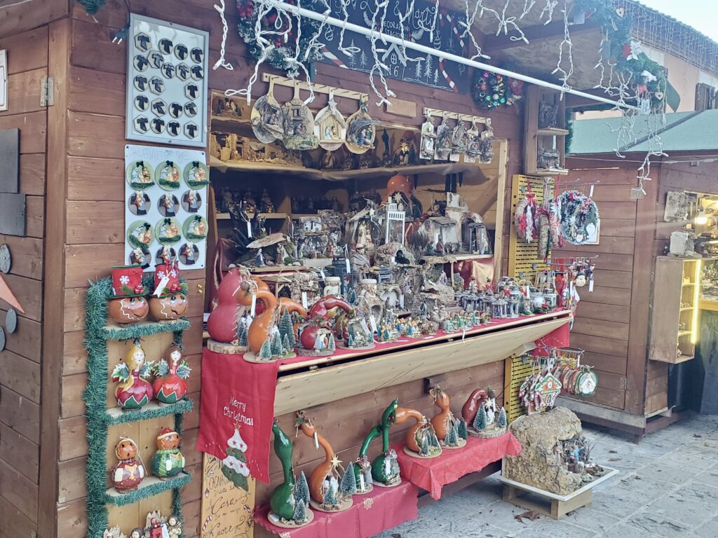 Stall with Nativity and Christmas items.