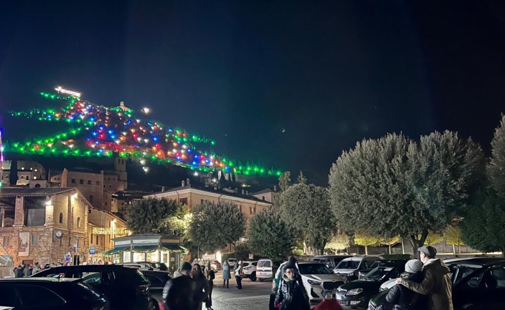 Italy mountainside covered with lights in the shape of a Christmas tree