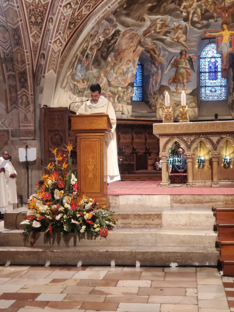 Deacon Dom Pastore reading the Gospel in the Basilica of St. Francis in Assisi, Italy